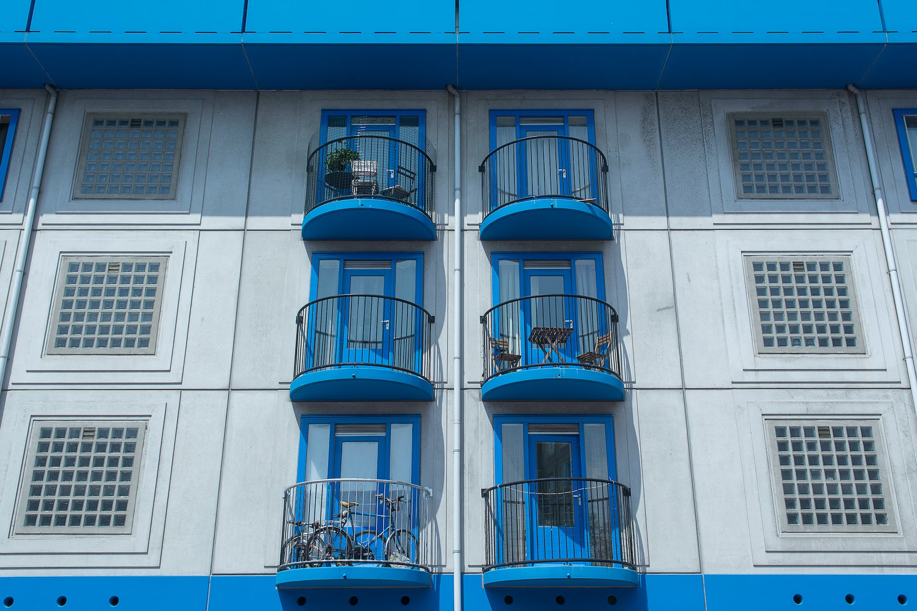 facade of an apartment building with blue balconies