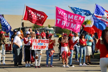 group of women holding banners supporting donald trump during the election