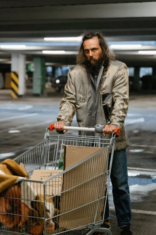 a homeless man at a parking lot