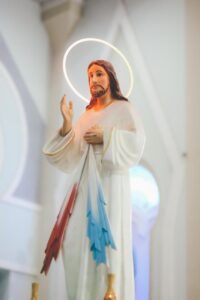 jesus christ figure with halo and beam from heart