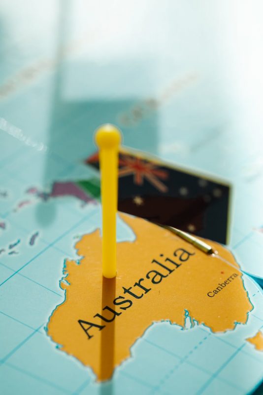 close up of australia on the world map and a plastic flag Support The Voice
